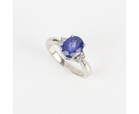 Sapphire and diamond ring, central oval cut sapphire weighing an estimated 2.23 carats, flanked either side by two round bril