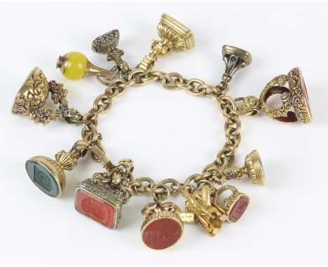 19th C gold charm bracelet, with belchers link stamped 9 ct and a padlock clasp, with ten seal fobs and two 9 ct charms, incl