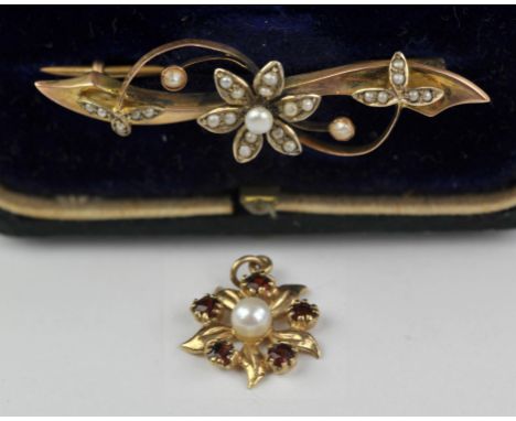 A floral motif seed pearl set bar brooch, in stamped 9 ct, in antique box, with a garnet and pearl floral pendant, in 9 ctCon