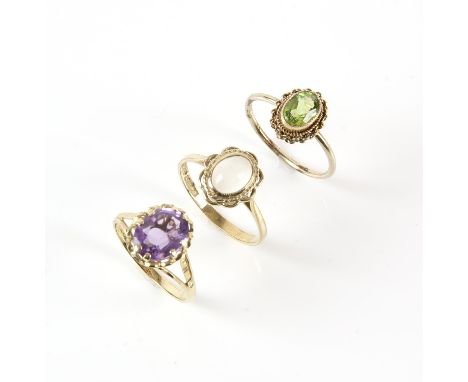 Three 9 ct single stone gem set rings, including a oval cut amethyst ring, size M, an oval cut peridot ring, size N, and a ov