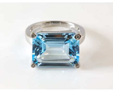 Blue topaz cocktail ring, centrally set with an emerald cut blue topaz, estimated weight 11.56 carats, with diamonds set claw