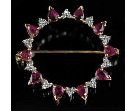 Ruby and diamond circular brooch, designed as alternating pear cut rubies and trefoils of round brilliant cut diamonds, in 9 