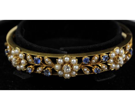 Diamond, pearl and sapphire hinged bangle, openwork floral motif set with three old cut diamonds, cream pearls and round cut 