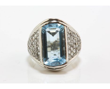 Blue topaz and cubic zirconia dress ring, central emerald cut blue topaz with rounded top and bottom, weighing an estimated 6