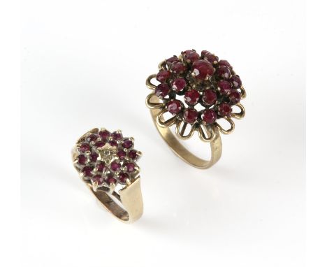 Two ruby cluster rings, one set with round cut rubies, in stamped 14 ct, ring size N, the other set with round cut rubies and