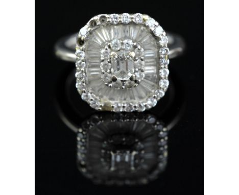 Diamond cluster cluster ring, with a central baguette cut diamond with a surround of round brilliant cut diamonds and baguett