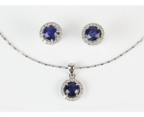 Sapphire and diamond cluster necklace and earring set, round cut sapphire weighing an estimated 1.45 carats, with a surround 