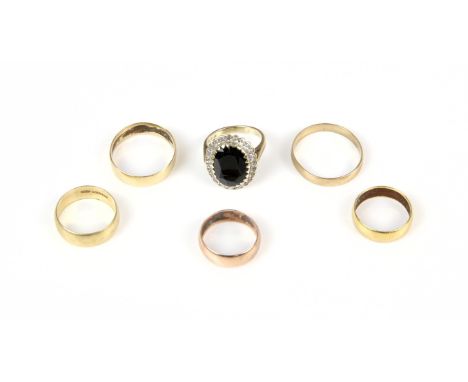 A sapphire and diamond cluster ring, in 9 ct, size M, two 9 ct wedding bands, sizes K and U, two 18 ct wedding bands, sizes R