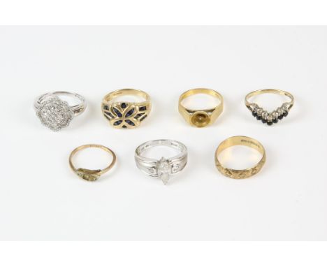 Seven gold rings including a diamond cluster ring in 9ct, a sapphire cluster ring in 9ct, a sapphire and paste wishbone ring 