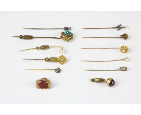 A collection of mostly 9 ct stick pins including two stick pins with a 'H' initial in antique boxes, four pearl set stick pin