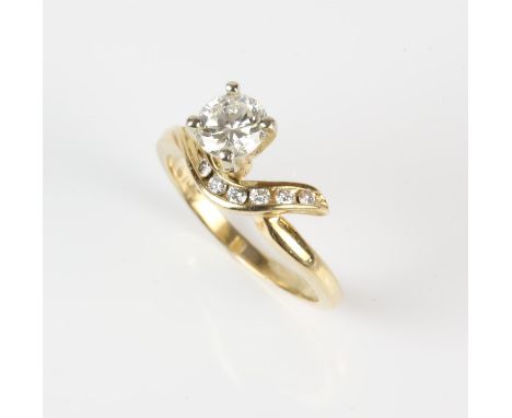 Contemporary diamond ring with central round brilliant cut diamond weighing a calculated 0.61 carat, claw set with a twist of