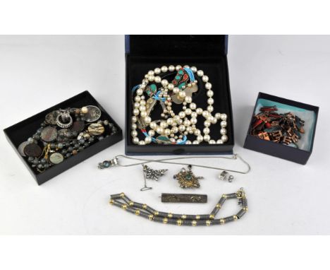 A selection of costume jewellery including a braided silver bangle, two faux pearl necklaces with silver clasps, a paste butt