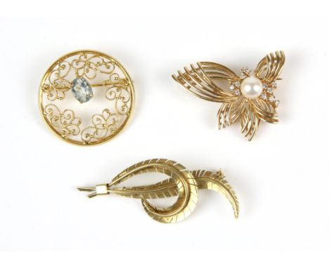 Three 14 ct brooches, including a pearl and diamond set brooch, a leaf motif brooch, and a openwork scroll motif brooch centr