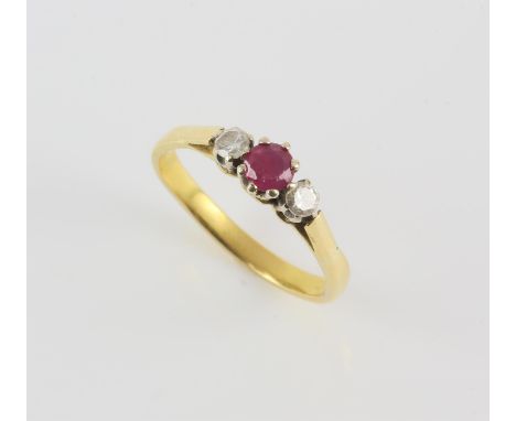 Ruby and diamond three stone ring, with central round cut ruby weighing an estimated 0.37 carats, flanked either side by a ro