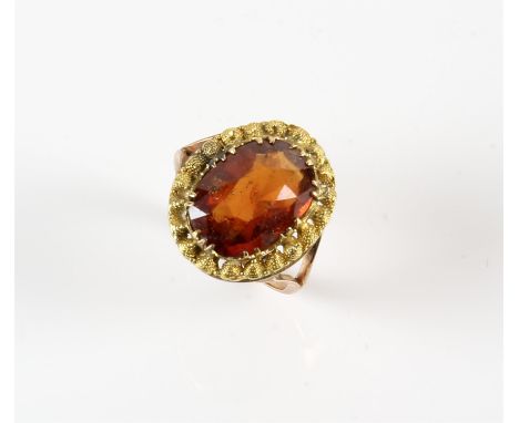 Hessonite garnet dress ring, oval mixed cut hessonite garnet weighing an estimated 5.70 carats, with a cannetille border, tes