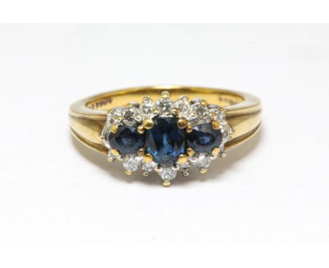 Sapphire and diamond cluster ring, three central sapphires surrounded by diamonds in a cluster design, set in 9 ct gold, stam