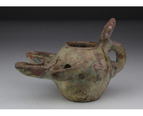 Seljuk Dynasty Oil Lamp, C. 1037 - 1194 A.D. Seljuk Glazed Earthenware Oil lamp with three spouts, handle and thumb guard. Ve