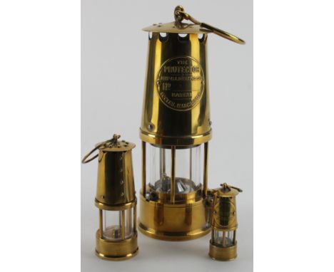 Miners Lamps. Three graduating brass miners lamps, largest one being 'The Protector Lamp & Lighting Co. Ld, Eccles, Mancheste
