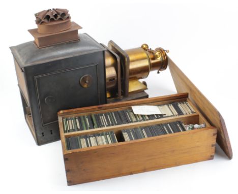 Lantern. A large brass magic lantern, circa late 19th to early 20th century, height 41cm, length 50cm, together with a box of