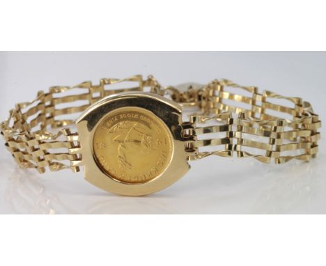 1981 1/10th Krugerrand coin set in a 9ct gate link bracelet mount with padlock clasp and safety chain, weight 9g.