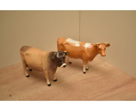 A Beswick Pottery Jersey Bull number 1422 in light brown with shading and darker head sold together with a Beswick Pottery Gu