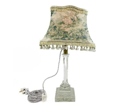 An Edwardian cut glass table lamp. Raised on an octagonal column and stepped star cut square base, height (excluding shade) 4