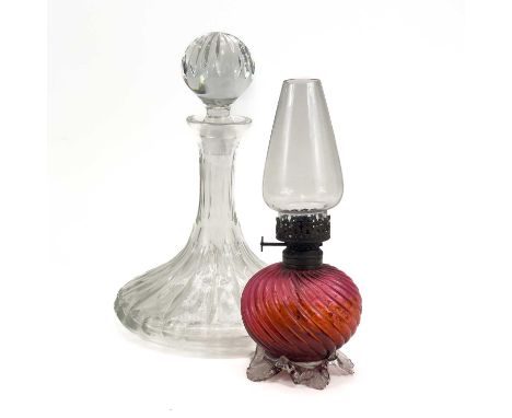 A cut glass ship's decanter and stopper. Height 26cm, together with a Victorian cranberry glass small oil lamp (2)