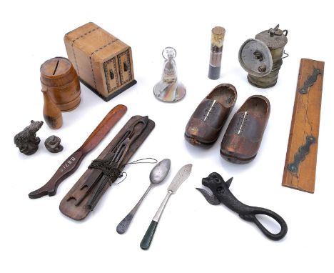 A 19th century glass vial displaying cassiterite at different stages of processing. Culminating in metal. Together with a box