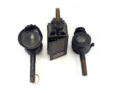 Two 19th century carriage lamps. 42cm and 38cm high, together with a railway lamp, 35cm high (3).