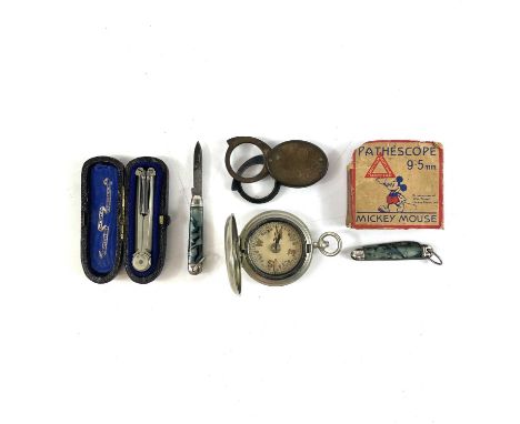 A Stanley nickel folding compass, cased. Together with a cased pocket compass, a Mickey Mouse 9.5mm reel, a magnifying loupe 