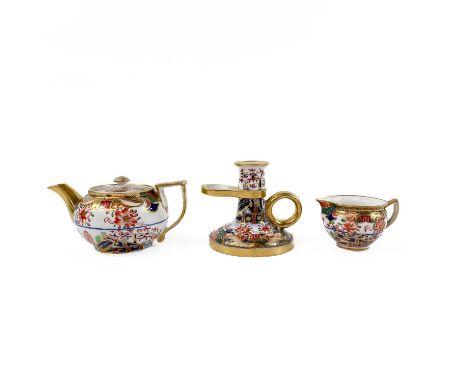 A Spode porcelain chamberstick decorated with pattern 967 and highly gilt. Height 6cm together with a Spode miniature teapot 