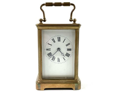 A French brass carriage clock. Striking on a coiled gong, leather case, height 13.5cm.