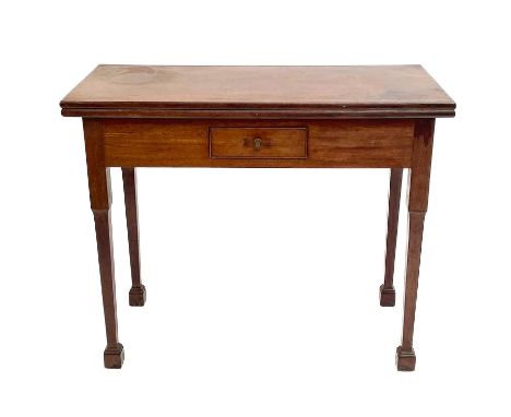 A George III mahogany and padouk games table. The folding top inlaid for chess and backgammon. fitted with a frieze drawer an