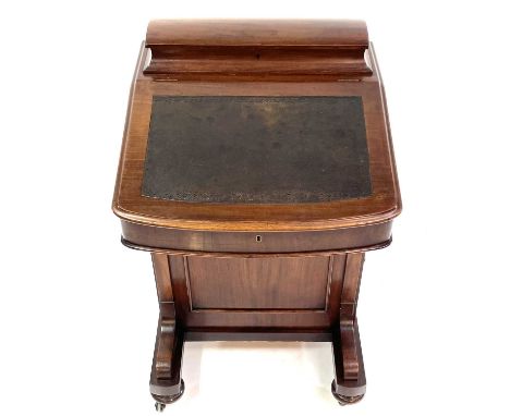 A Victorian mahogany Davenport desk stamped Jas Shoolbred &amp; Co. With a sloping front before a stationery compartment and 