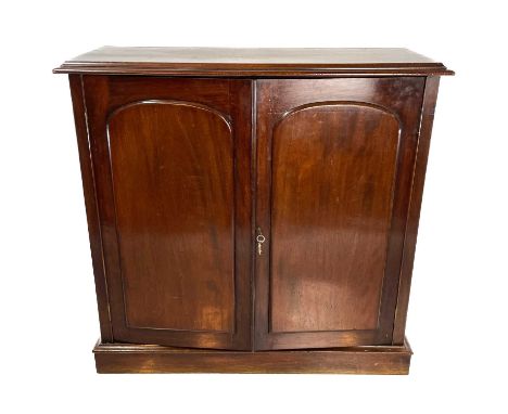 A Victorian mahogany cupboard. Fitted two arch panel doors enclosing shelves, on a plinth base, height 100.5cm, width 105cm, 