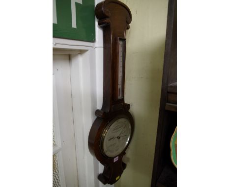 An oak aneroid banjo barometer.