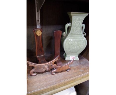 A Chinese celadon twin handled vase, 25cm high; together with two Chinese hardwood plate stands.   Condition Report: Firing c