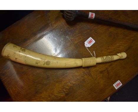 Ethnographica: a tribal carved ivory pipe, decorated with stylized figures, 46.5cm long.  Condition Report: Not sure what typ