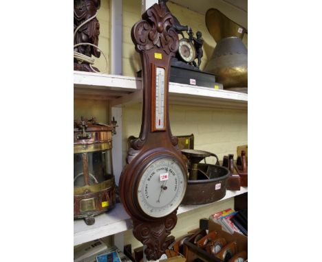 A carved walnut aneroid banjo barometer.    