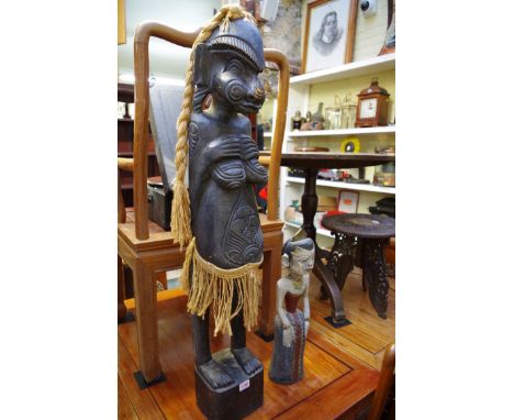 Ethnographica: a tribal carved wood figure,100cm high; together with another polychrome painted figure, 50cm high.