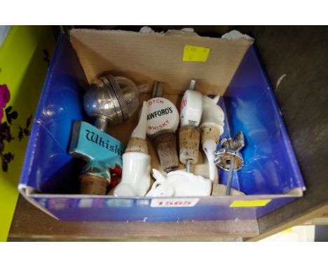 A small quantity of novelty bottle stoppers, to include an electroplated and enamel Haig example. 