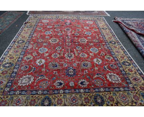 A large Persian Tabriz carpet, having all over floral palmette design, on soft red field with floral palmette yellow border. 