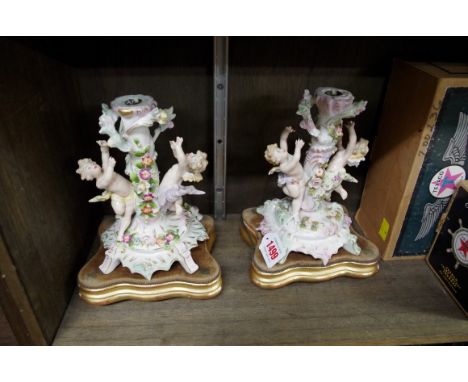 A pair of Sitzendorf figural candlestick bases. 