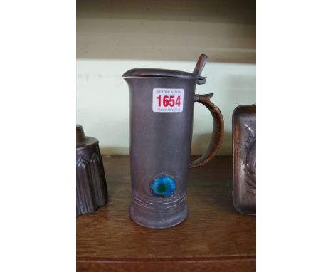 A Liberty pewter and enamel lidded jug or flagon, by Archibald Knox, pattern 0280, 19cm high.     Condition Report:  Slight d