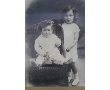 A large vintage early 20th century black and white photograph portrait of two children. The picture unmarked and unsigned. Me