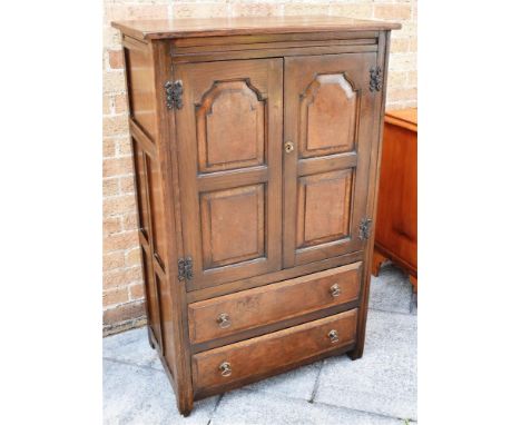 AN OAK AND ELM TALL BOY, the twin doors opening to reveal a fitted shelf above two long drawers, H122.5cm x W 76xn x D 48cm