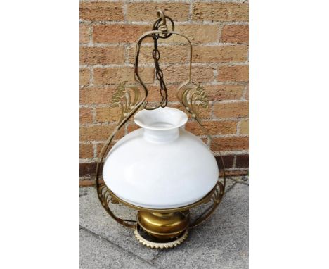 AN EDWARDIAN HANGING OIL LAMP  with opaque glass shade, the metal frame wtih Art Nouveau style decoration