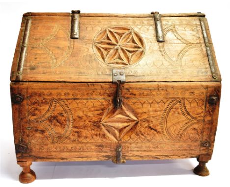 A GEOMETRIC CARVED BOX with compass decoration, possibly of Scandinavian origin, and raised on four circular legs, H 40cm x W