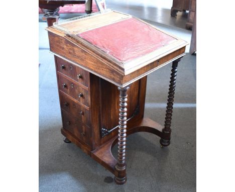 VICTORIAN ROSEWOOD DAVENPORT, the top having a brass galleried back, and sloping writing surface with a maroon leather insert