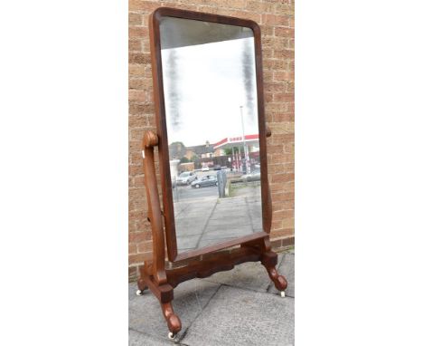 19TH CENTURY MAHOGANY CHEVAL MIRROR and raised on ceramic casters, the mirror measuring H 119cm x W 58cm, overall H 165cm x W